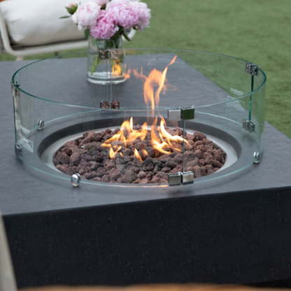 Metropolis Fire Table Dark Gray Sofas Flowers with Windguard and Flame Closeup
