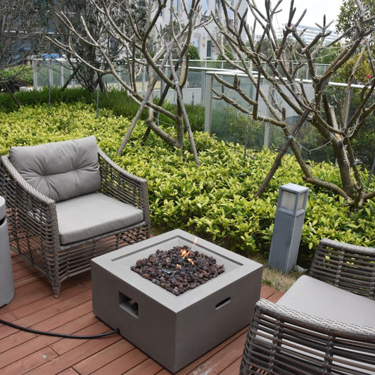 Modeno Ridgefield Fire Pit with flame near couch Backyard lifestyle